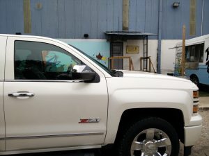 Chevy Silverado parked in front of Hops and Grain Chevy loves Local